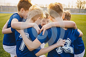 Happy boys in junior football team celebrating success. Happy kids in school sports team.