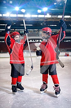 Happy boys players ice hockey winner trophy