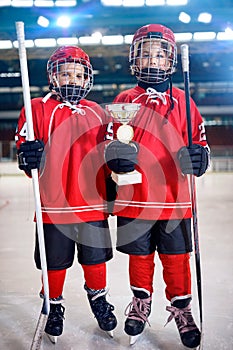 Happy boys players ice hockey winner trophy