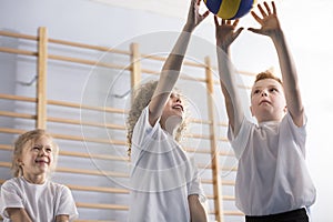 Happy boys playing volleyball