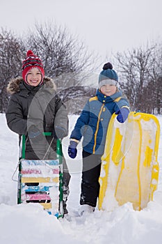 Happy boys on sled and Skis