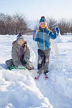 Happy boys on sled and Skis