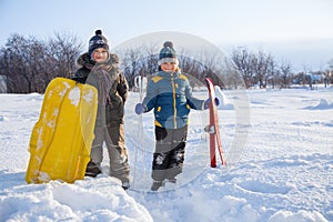 Happy boys on sled and Skis