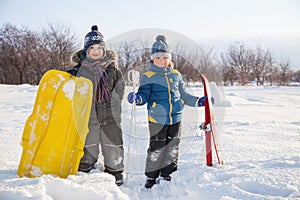 Happy boys on sled and Skis