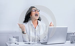 Happy brazilian woman shouting at work place