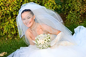 Happy bride with a flower bouquet in her hands