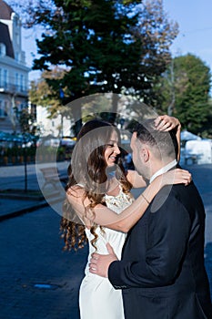 Happy bride and groom. Cheerful married couple. Just married couple embraced. Wedding couple