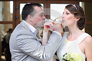 Happy bride and groom drinking
