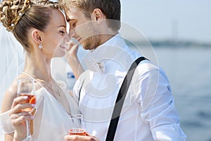 Happy bride and groom drinking champagne