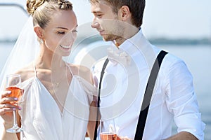 Happy bride and groom drinking champagne