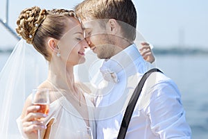 Happy bride and groom drinking champagne