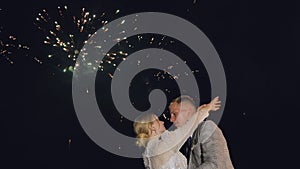 The happy bride and groom in front of the fireworks.