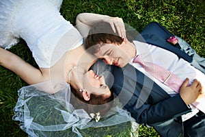 Happy bride and groom on grass