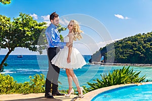 Happy bride and groom having fun on a tropical beach