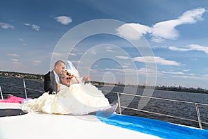 Happy bride and groom on a luxury yach