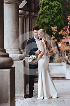 Happy bride and groom near old castle