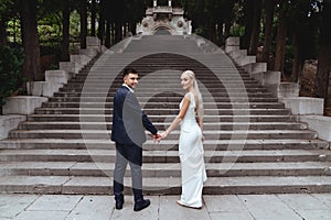 Happy bride and groom near old castle