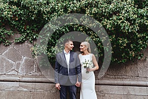 Happy bride and groom near old castle