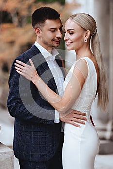 Happy bride and groom near old castle