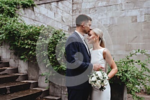 Happy bride and groom near old castle