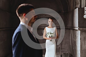 Happy bride and groom near old castle