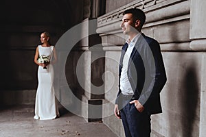 Happy bride and groom near old castle