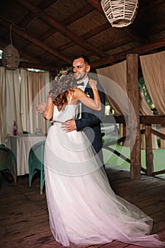 Happy bride and groom and their first dance, wedding in the elegant restaurant with a wonderful light and atmosphere