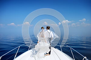 Happy bride and groom on a yacht