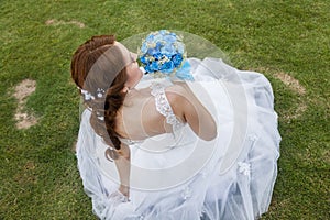 Happy bride holding bouquet of flowers