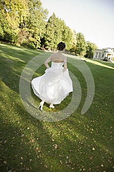 Happy Bride Running In Park