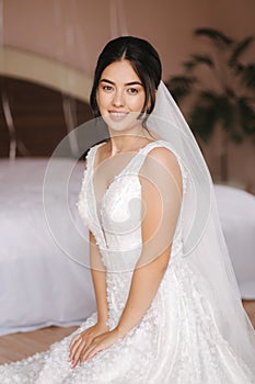 Happy bride sit in wedding dress and smiled. Bridde with bouquet