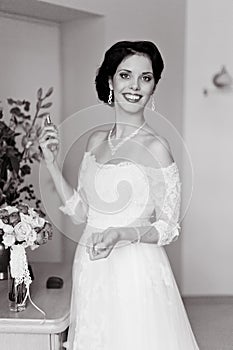 Happy Bride spraying perfume