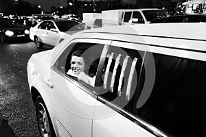 Happy bride in wedding limo