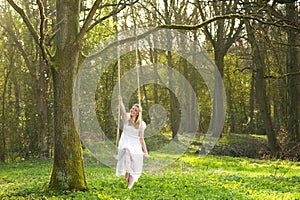 Happy bride in white wedding dress sitting on a sw