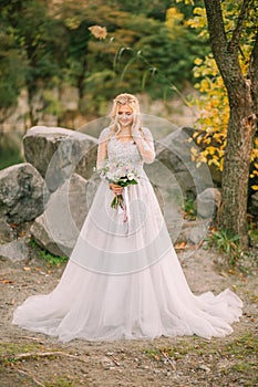 happy bride woman holding wedding creative bouquet white purple rose flowers berries eucalyptus plant bridal long white