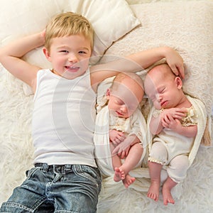 Happy brother with twin babies