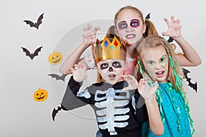 Happy brother and two sisters on Halloween party