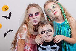 Happy brother and two sisters on Halloween party