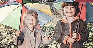 Happy brother with umbrella outdoors
