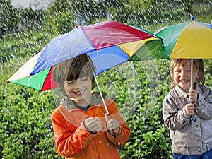 Happy brother with umbrella outdoors