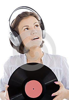 Happy brunette in headphones with vinyl record