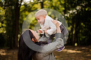 Happy brunette mother playing with a cute baby daughter