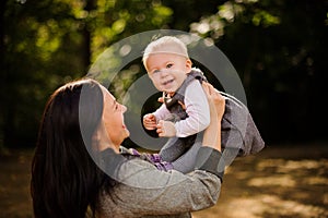 Happy brunette mother playing with a laughing daughter