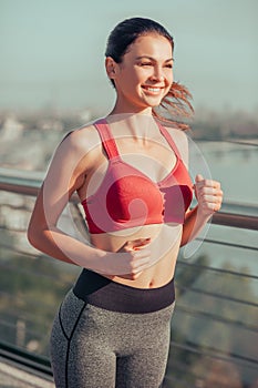 Happy brunette woman exercising outdoors alone