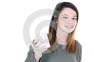 Happy brunette woman holding tea mug coffee and looking at the camera with back copy space