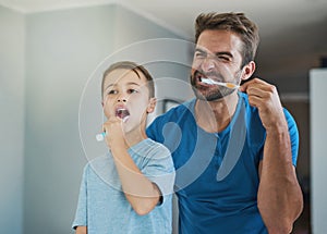 Happy, brushing teeth and father with son in bathroom for morning routine, bonding and dental. Oral hygiene, cleaning