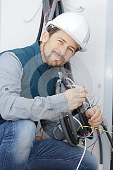 happy builder dealing with electrical board