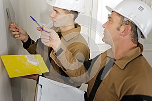 happy builder in hardhat plastering wall