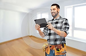 Happy builder with tablet computer and tools