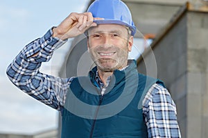 happy builder worker at construction site